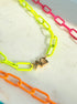 Neon enamel necklace close up with 2 gold initials 