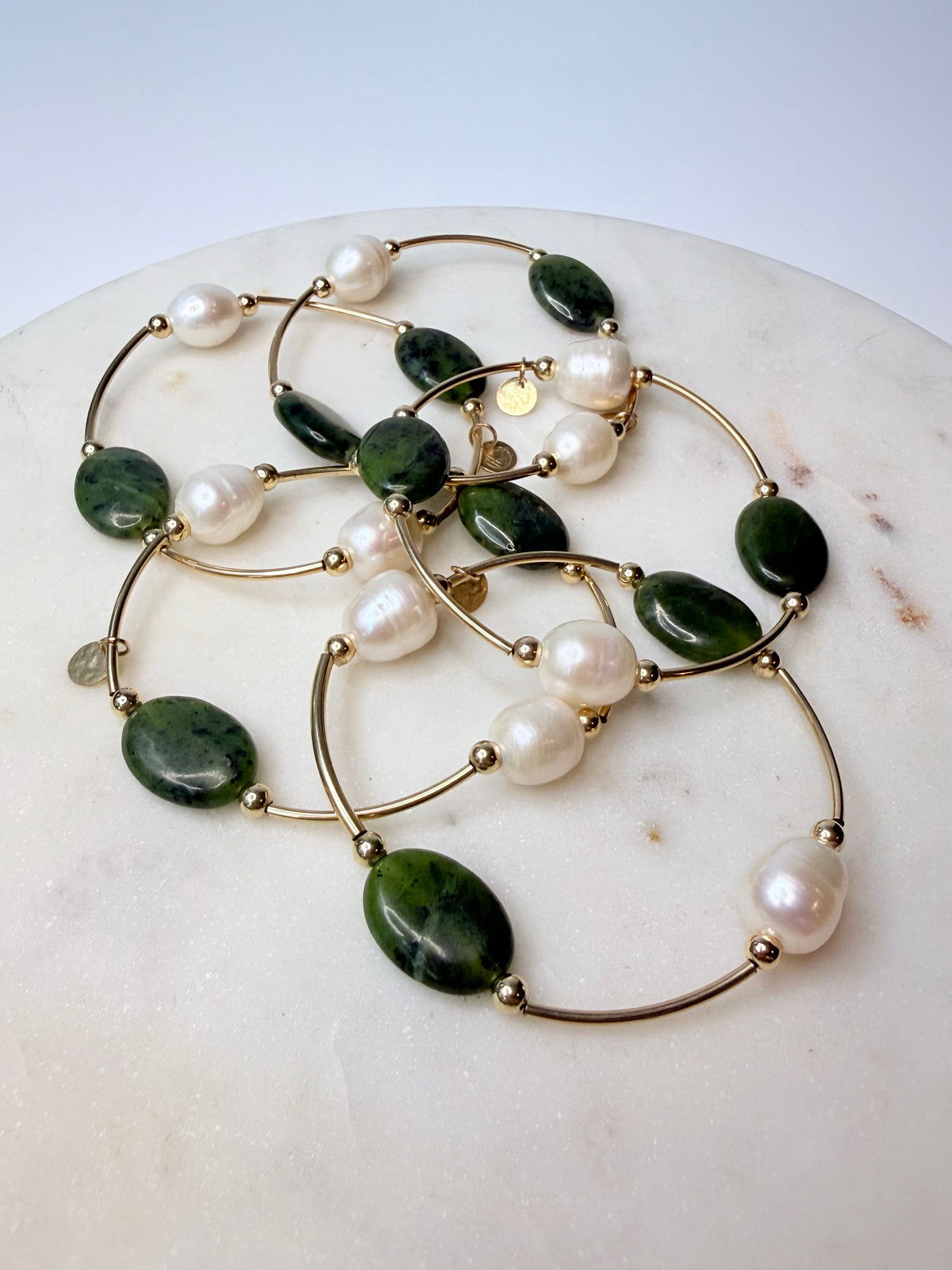 Multiple Olivine jade and freshwater pearl gold-filled bracelets by Gypsy & Gem